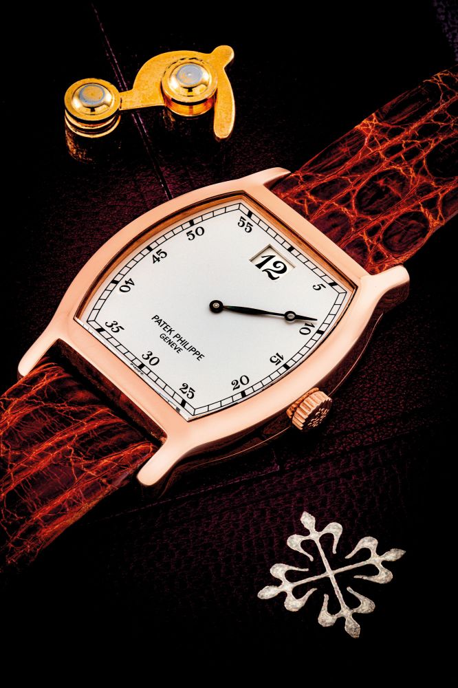 PATEK PHILIPPE. A RARE 18K PINK GOLD LIMITED EDITION TONNEAU SHAPED JUMP HOUR WRISTWATCH, MADE TO COMMEMORATE THE 150TH ANNIVERSARY OF PATEK PHILIPPE