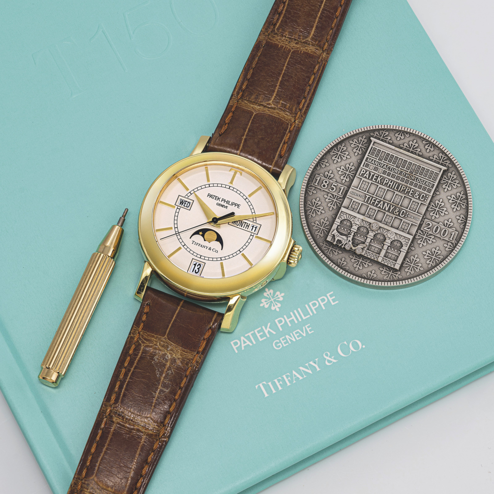 PATEK PHILIPPE. A RARE 18K GOLD LIMITED EDITION AUTOMATIC ANNUAL CALENDAR WRISTWATCH WITH SWEEP CENTRE SECONDS AND MOON PHASES, MADE TO CELEBRATE THE 150TH ANNIVERSARY OF THE RELATIONSHIP BETWEEN PATEK PHILIPPE AND TIFFANY & CO.