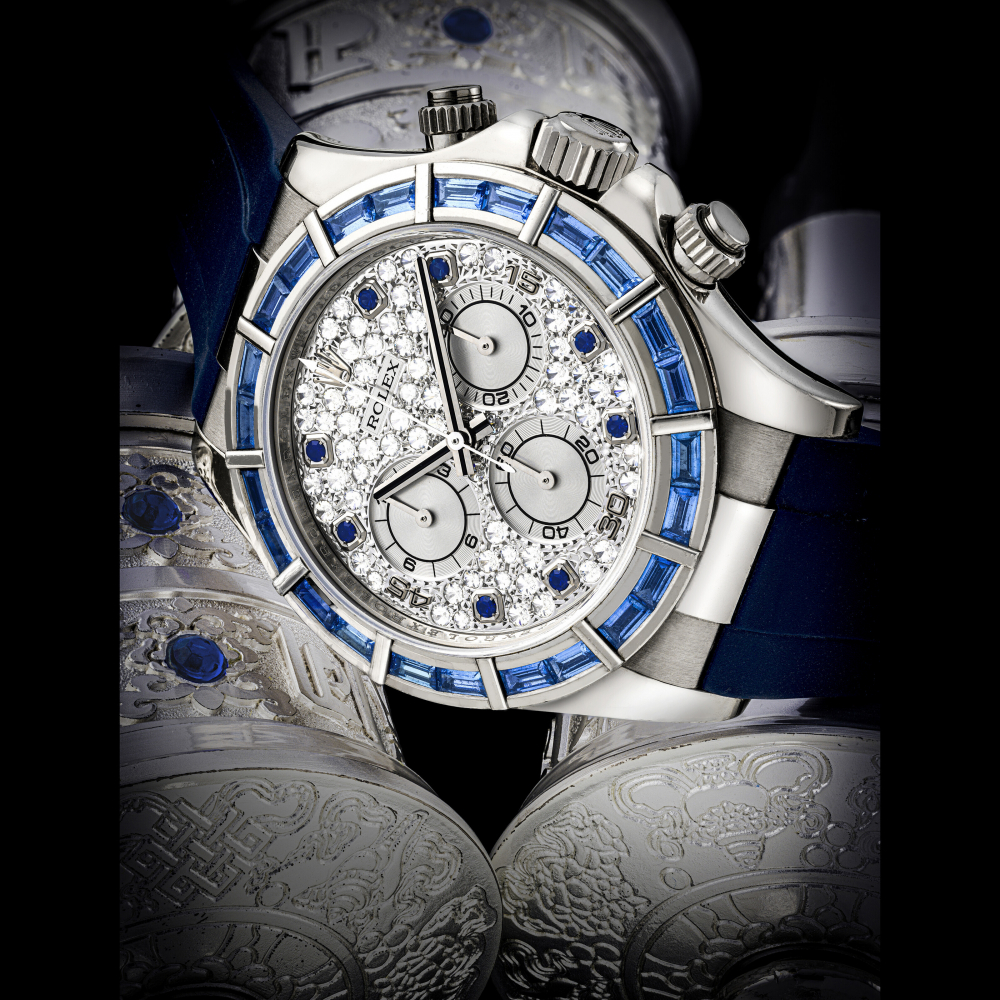 ROLEX. A VERY RARE 18K WHITE GOLD, DIAMOND AND SAPPHIRE-SET AUTOMATIC CHRONOGRAPH WRISTWATCH