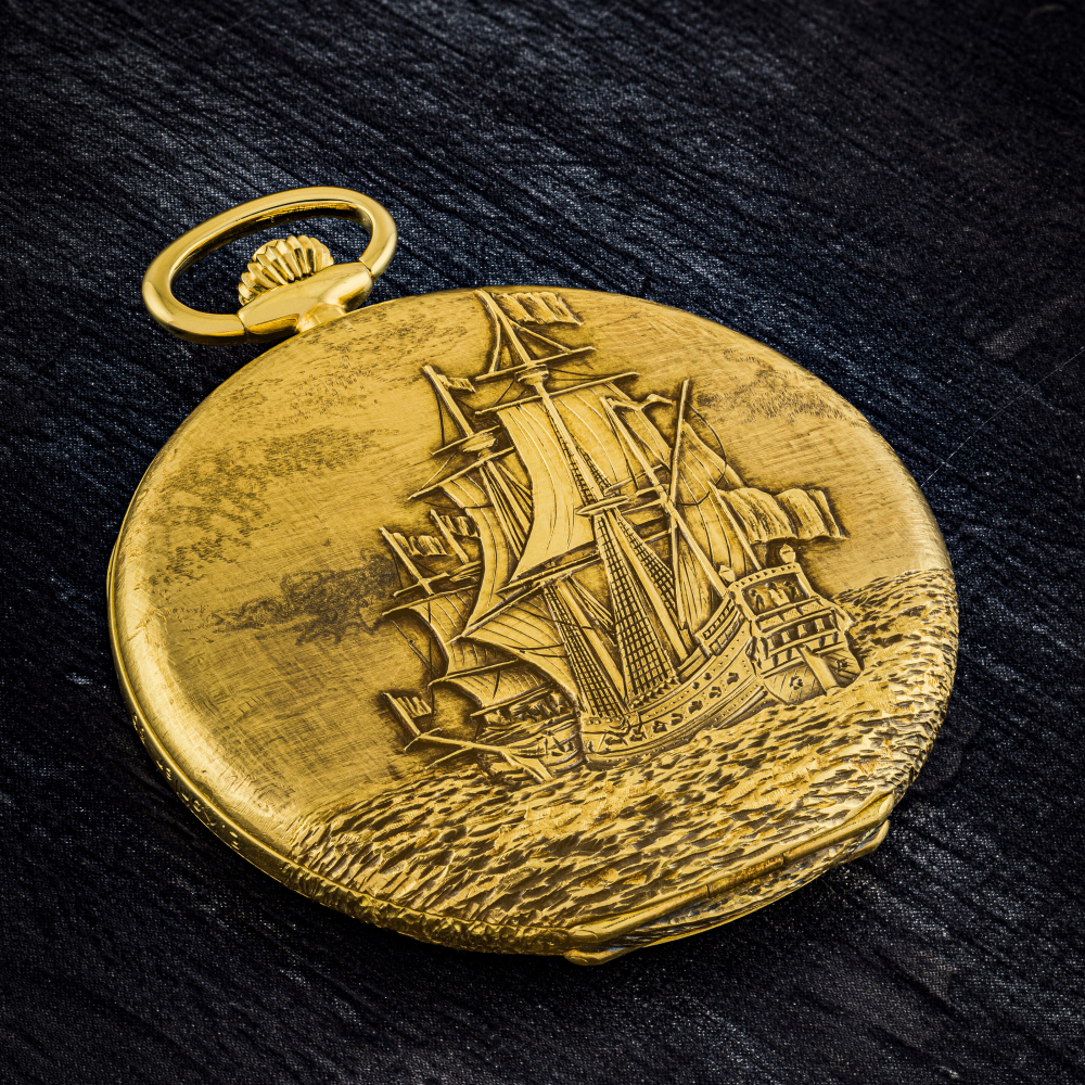 PATEK PHILIPPE. A POSSIBLY UNIQUE 18K GOLD HUNTER CASE POCKET WATCH WITH ENGRAVED SCENES OF “NAVIRES ANCIENS DU XVIE SIÈCLE” AND BREGUET NUMERALS