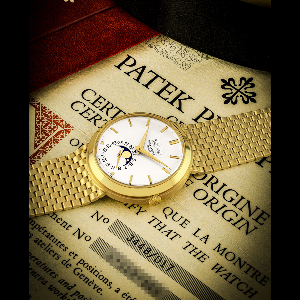 PATEK PHILIPPE. AN EXTREMELY RARE AND WELL PRESERVED 18K GOLD AUTOMATIC PERPETUAL CALENDAR WRISTWATCH WITH MOON PHASES, BRACELET AND GERMAN CALENDAR