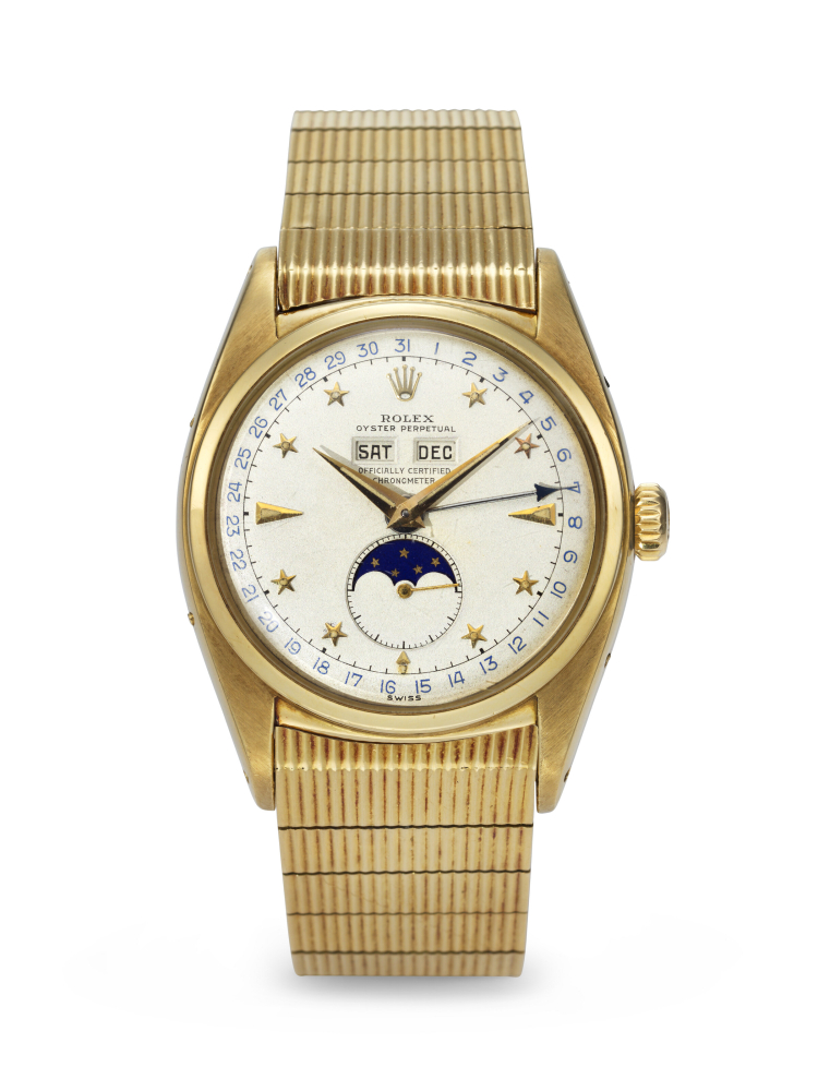 ROLEX. AN EXCEEDINGLY RARE AND SUPERBLY PRESERVED 18K GOLD AUTOMATIC TRIPLE CALENDAR WRISTWATCH WITH MOON PHASES, LUMINOUS STAR HOUR MARKERS AND BRACELET