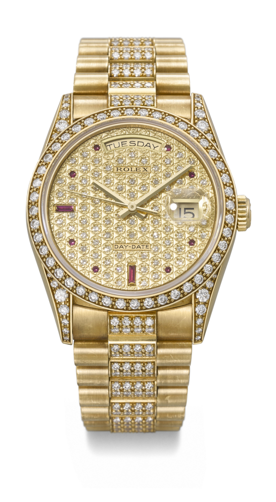 ROLEX. A VERY RARE AND DAZZLING 18K GOLD, DIAMOND AND RUBY-SET AUTOMATIC WRISTWATCH WITH SWEEP CENTRE SECONDS, DAY, DATE AND BRACELET