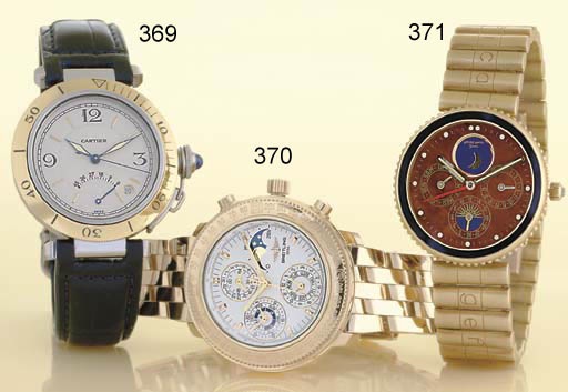 GERALD GENTA. AN UNUSUAL 18K GOLD ALARM BRACELET WATCH WITH DAY, DATE, 24 HOURS AND MOON PHASES