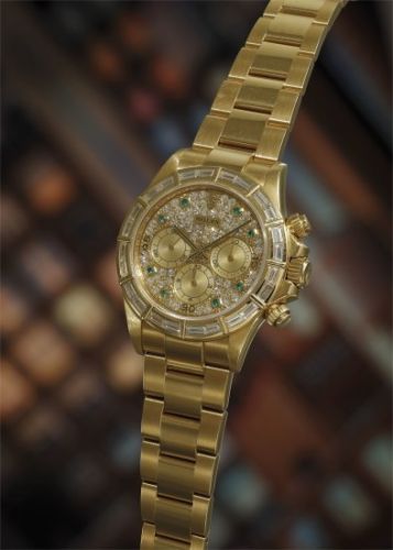 Rolex Follow;Ref. 16568;A very rare and attractive yellow gold chronograph wristwatch with diamond-set bezel and dial, emerald-set hour markers and bracelet, accompanied by presentation box, leather pouch, cloth, booklet and guarantee.