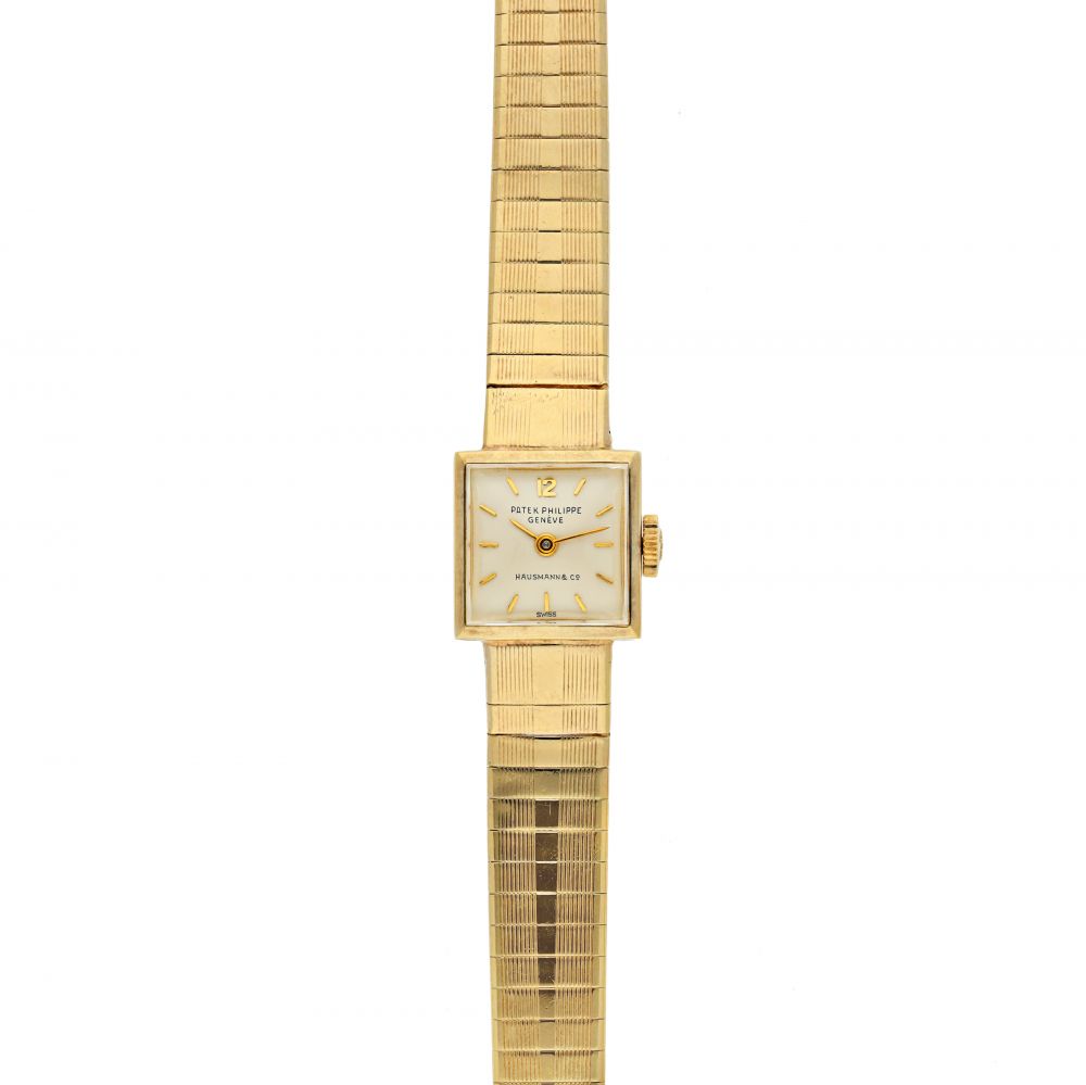 PATEK PHILIPPE | REFERENCE 3086/67 RETAILED BY HAUSMANN & CO.: A YELLOW GOLD SQUARE FORM BRACELET WATCH, CIRCA 1970
