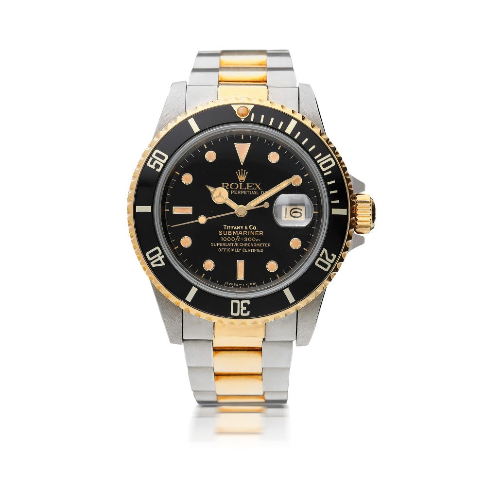 ROLEX | REFERENCE 16803 SUBMARINER RETAILED BY TIFFANY & CO.: A STAINLESS STEEL AND YELLOW GOLD AUTOMATIC CENTER SECONDS WRISTWATCH WITH DATE AND BRACELET, CIRCA 1986