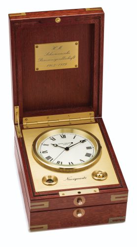 Patek Philippe.A RECTANGULAR CENTRE SECONDS TIMEPIECE IN A BRASS BOUND ROSEWOOD CASE WITH POWER RESERVE INDICATION REF 1215 CASE 1802629 NAVIQUARTZ MADE IN 1979