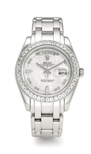 Rolex.A RARE AND IMPRESSIVE PLATINUM AND DIAMOND-SET AUTOMATIC WRISTWATCH WITH CENTRE SECONDS DAY DATE METEORITE DIAL AND BRACELET REF 18956 CASE K597044 DAY-DATE CIRCA 2001