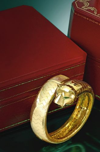 Cartier A LADY'S YELLOW GOLD BANGLE WATCH PANTHÈRE CIRCA 1990