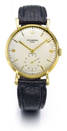Patek Philippe RETAILED BY HAUSMANN & CO.: A FINE YELLOW GOLD MANUALLY WINDING WRISTWATCH REF 1543 MVT 963816 CASE 653580