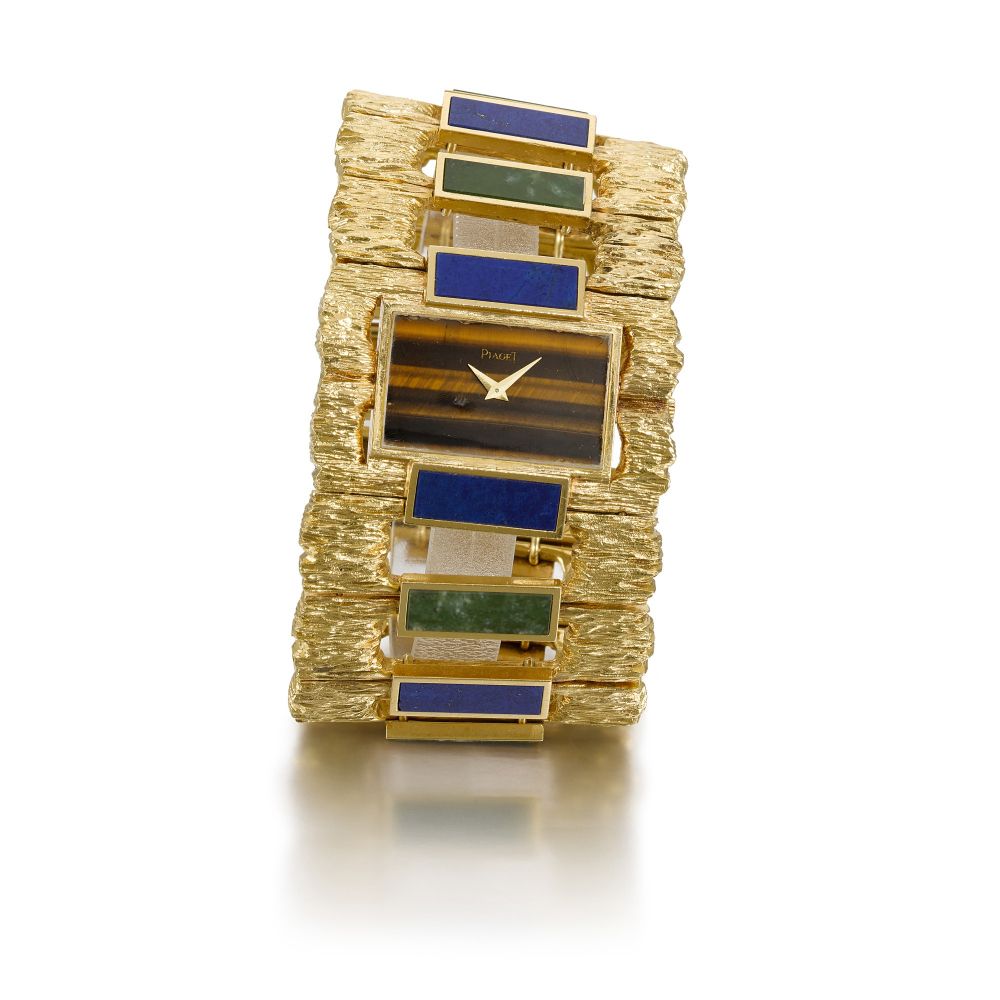 PIAGET | MANCHETTE REFERENCE 9212, YELLOW GOLD TIGER EYE LAPIZ LAZULI AND AGATE CUFF WATCH, CIRCA 1970