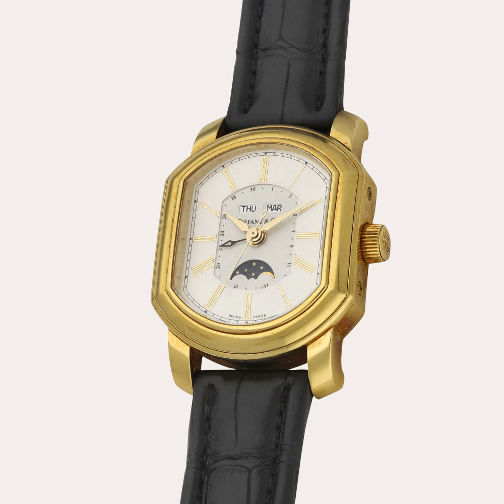 Tiffany & Co. A yellow gold triple calendar wristwatch with moon phases | Circa 1990
