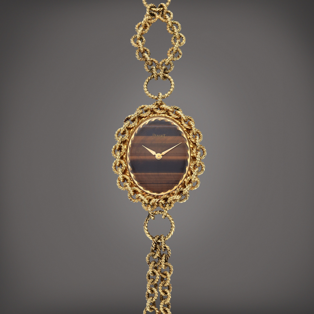 Reference 6865 P 74 | A yellow gold oval-shaped sautoir watch with tiger’s eye dial, Circa 1975