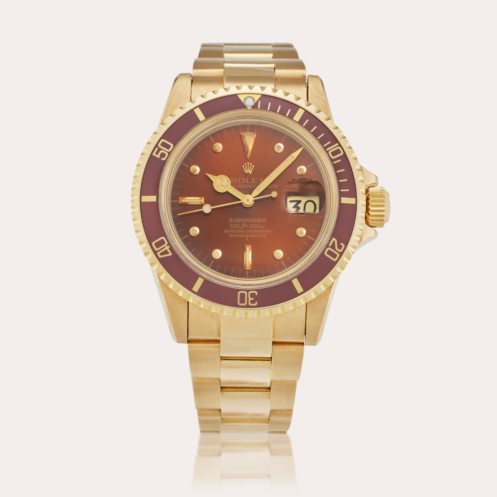 Rolex Reference 1680 Submariner | A yellow gold automatic wristwatch with date, bracelet, and tropical nipple dial, Circa 1975